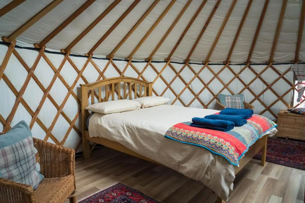 a bedroom with a bed in a yurt at Shepherd's Loch Glamping in Turriff