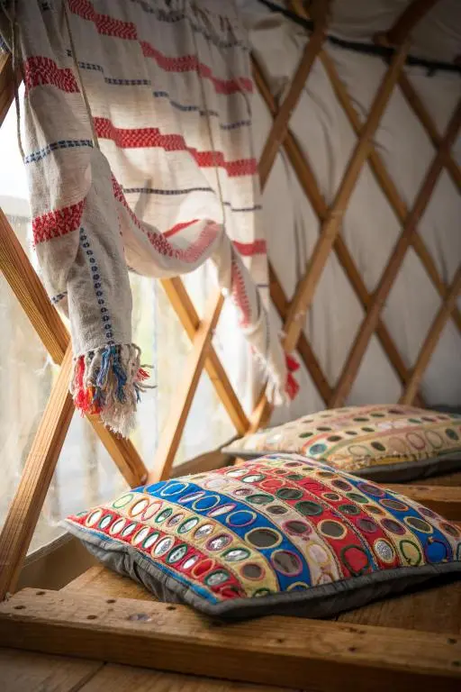 a pillow sitting on a wooden table in a yurt at Shepherd's Loch Glamping in Turriff