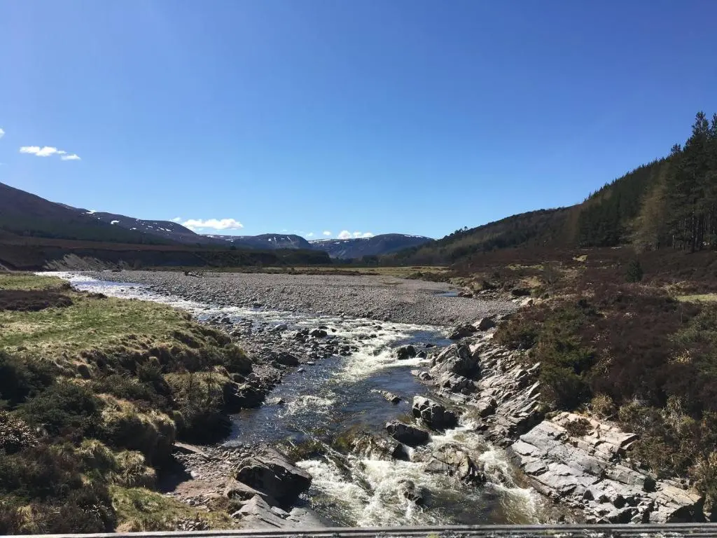 a river in the middle of a valley at Glenfeshie Hostel in Insh