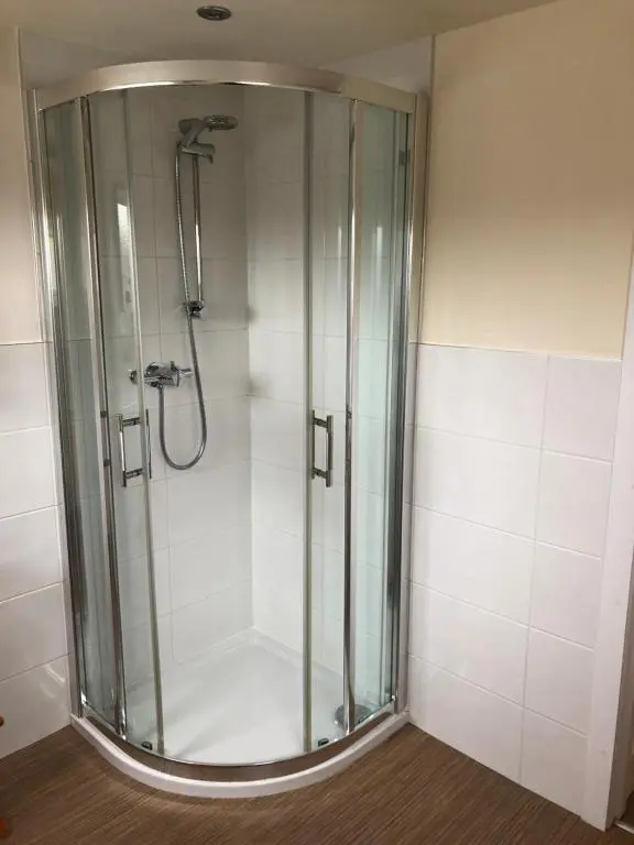 a shower with a glass door in a bathroom at The Aberdeen Arms Hotel in Tarves