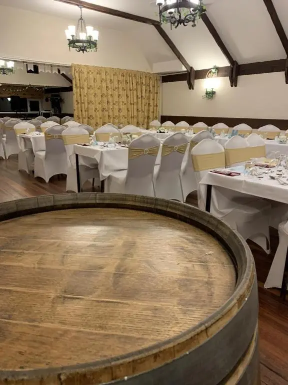 a banquet room with white tables and white chairs at The Aberdeen Arms Hotel in Tarves