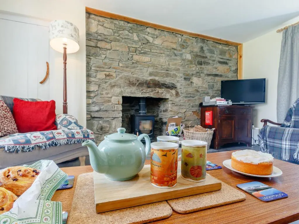 a table with a tea pot and two cups on it at 19 South Street in Grantown on Spey