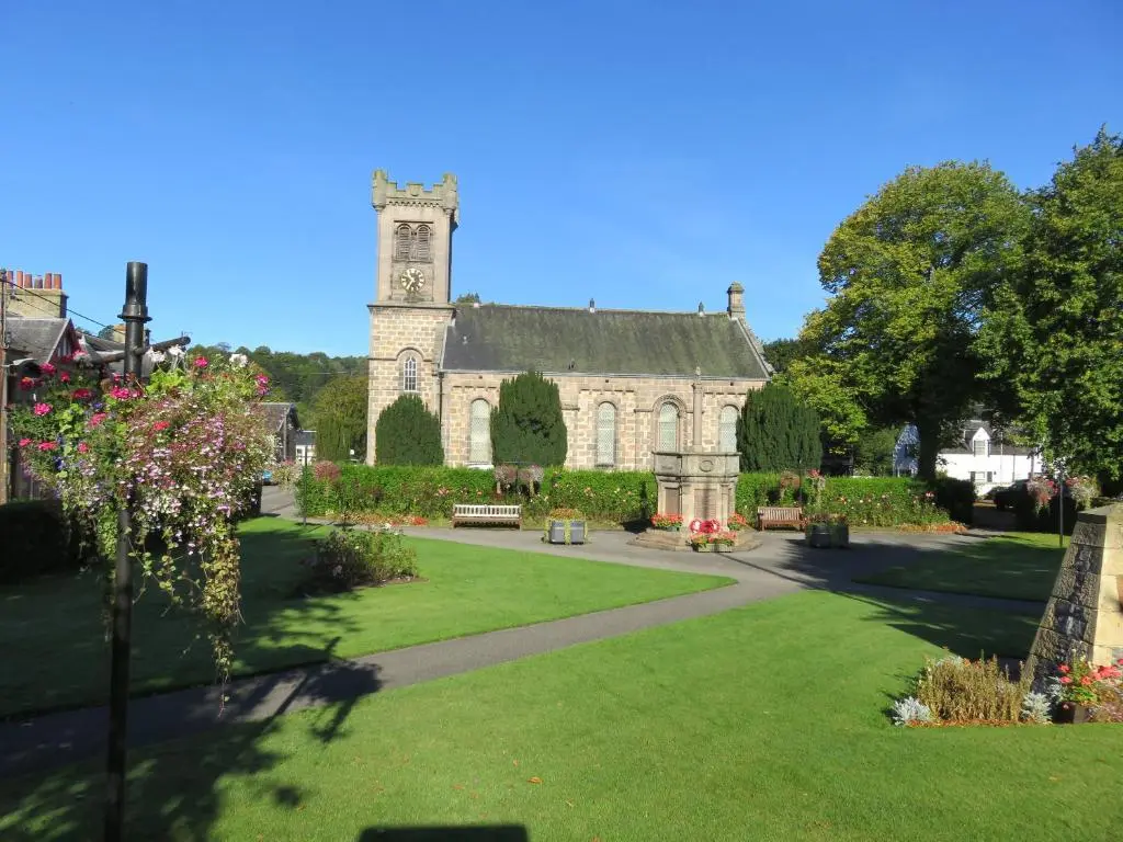 an old building with a clock tower in a park at Bankhouse B&B in Aberlour