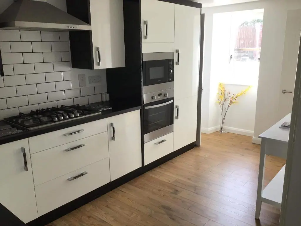 a kitchen with white cabinets and a stove top oven at 4-Bed Cottage in Portknockie Near Cullen Moray in Portknockie