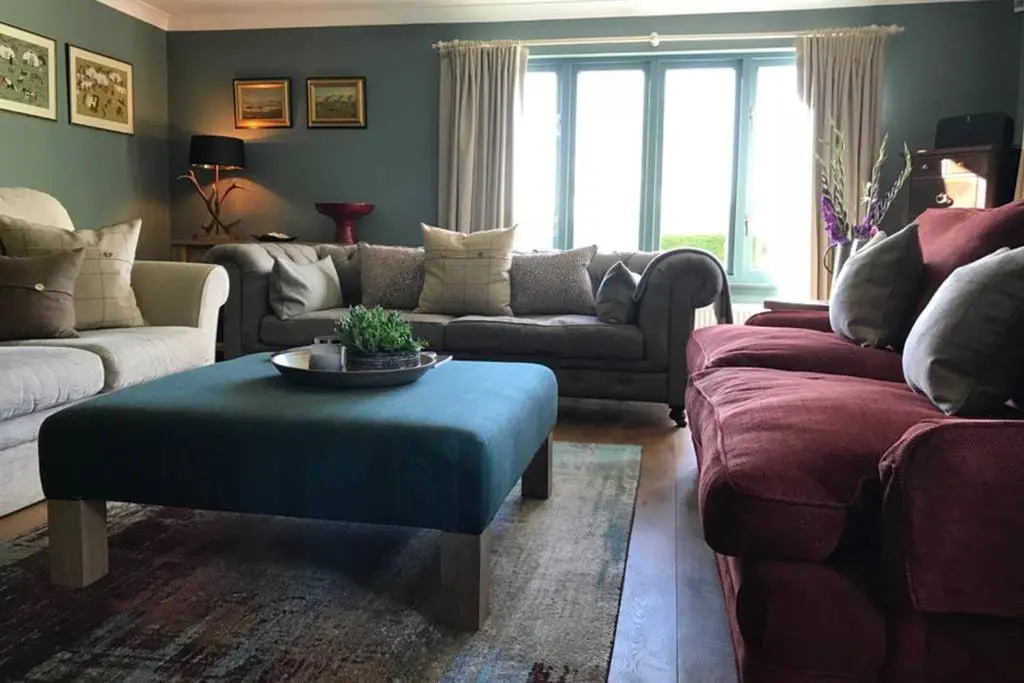 a living room with couches and a coffee table at Highfield House in Dornoch