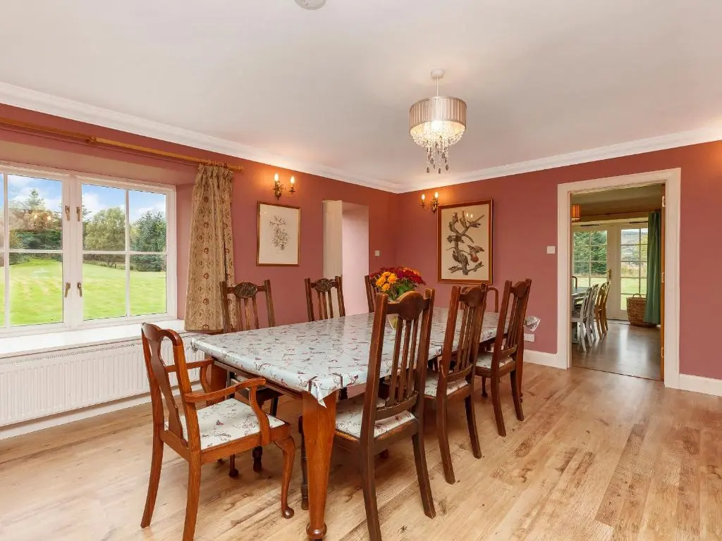 a dining room with a table and chairs at Rowan House in Inveran