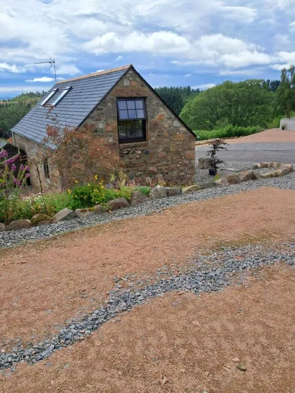 a stone house on the side of a road at Boghead Cottage: Holiday Cottage in Royal Deeside in Banchory