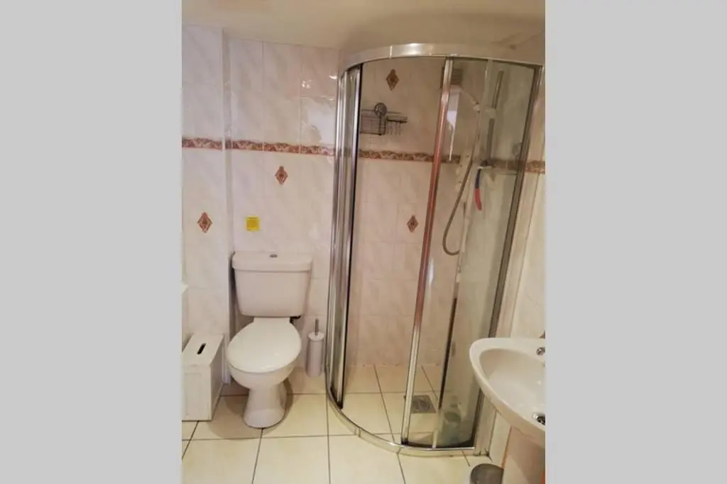 a bathroom with a toilet and a shower and a sink at Boghead Cottage: Holiday Cottage in Royal Deeside in Banchory