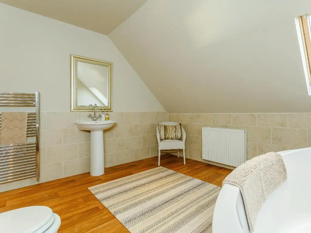 a bathroom with a sink and a toilet in a room at The Big Hoose in Achnahanat