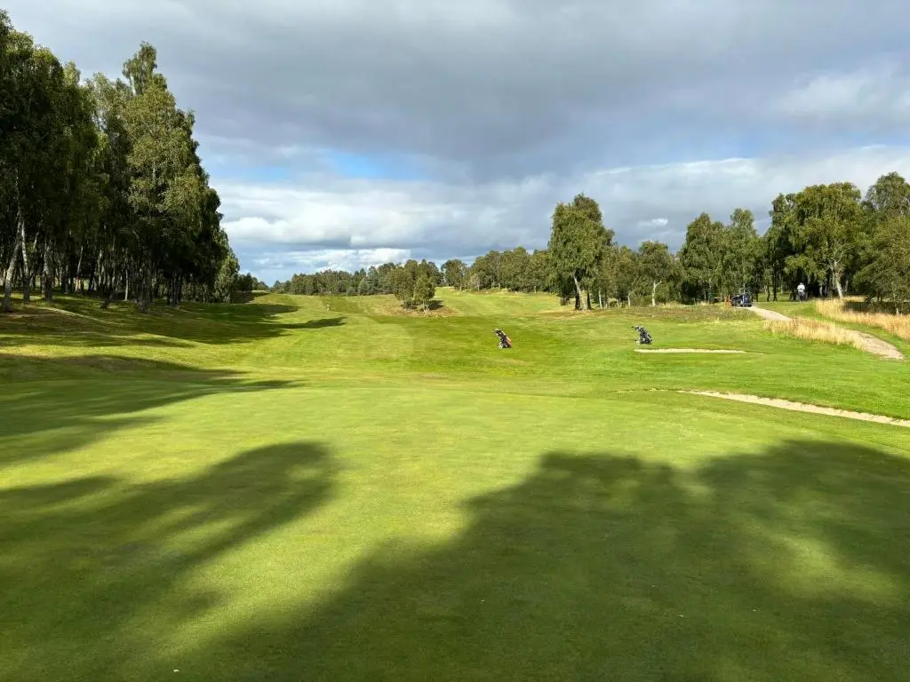 a shadow of a person on a golf course at Cairngorm Cottage in Aviemore