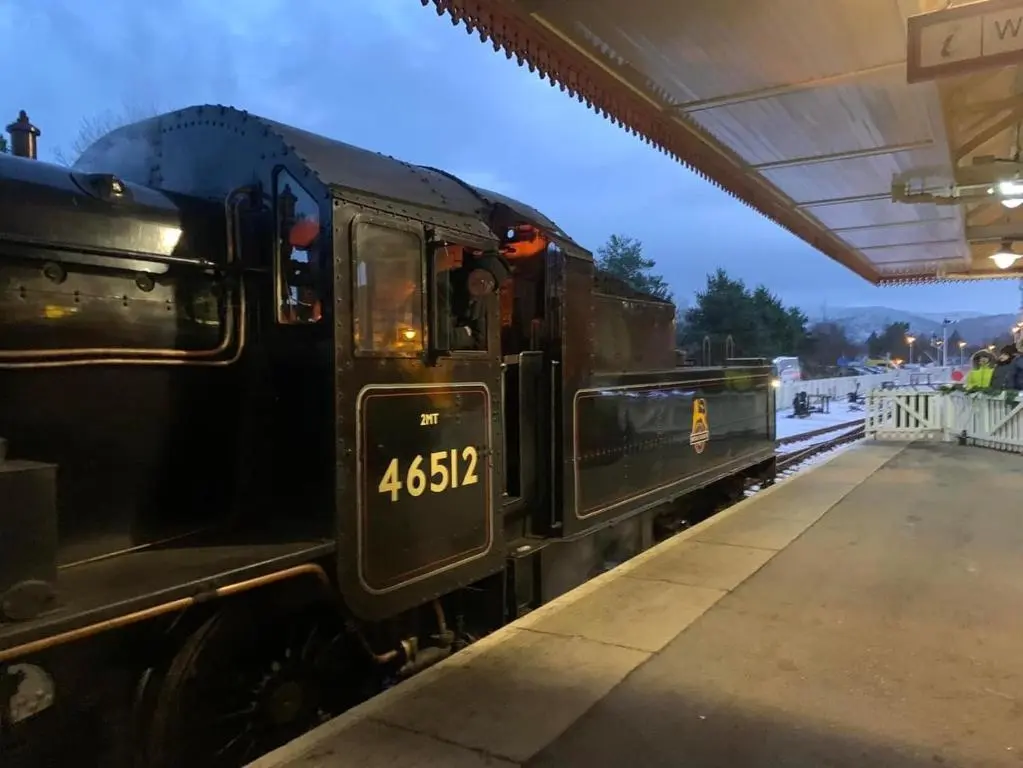 a black train parked at a train station at The One - Chalet in the Cairngorms in Boat of Garten