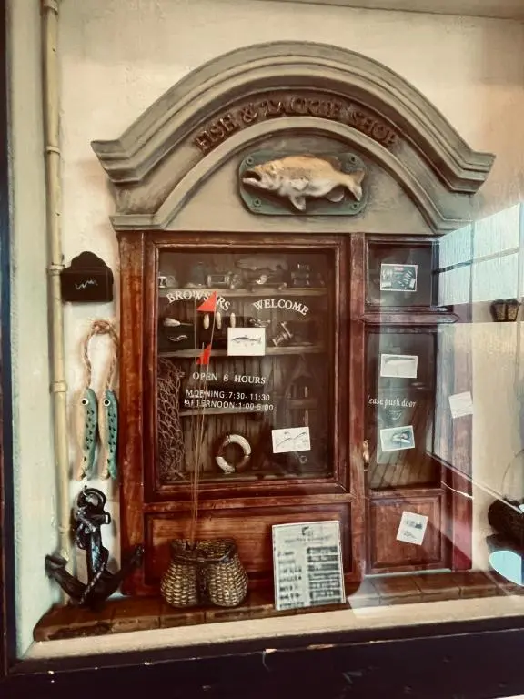 a display window of a store with a fish in it at Talisker in Nairn