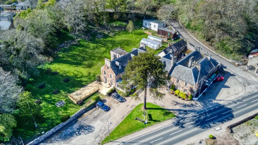 an aerial view of a house with a palm tree at Golspie Inn in Backies