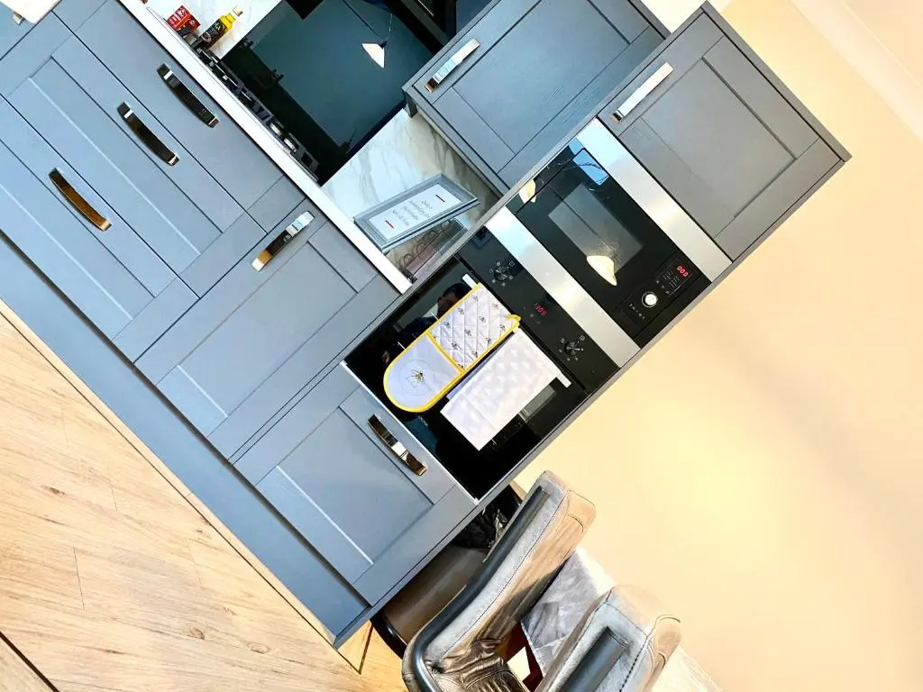 an overhead view of a kitchen with blue cabinets at Serviced Accommodation Moray Lesmurdie House, Elgin - Free Parking, Free WiFi in Elgin