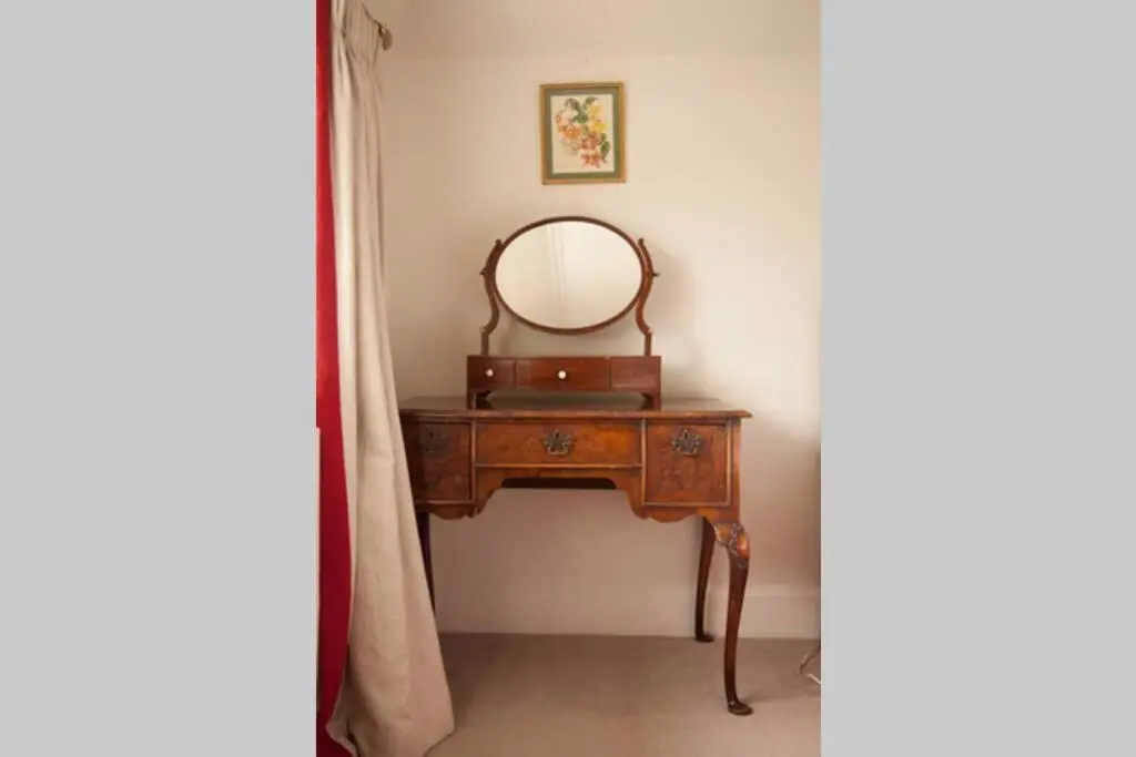 a dressing table with a mirror on top of it at Garden Cottage, Fochabers in Fochabers