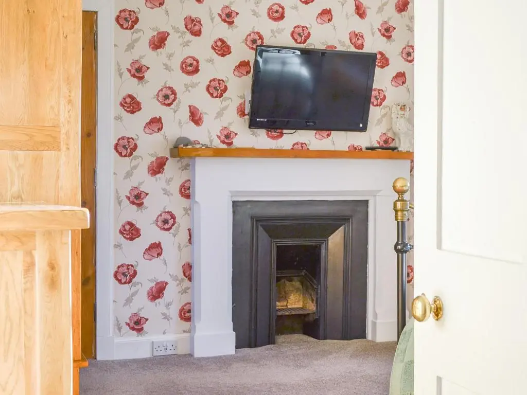 a fireplace with a television on top of it at Brighton House in Nairn
