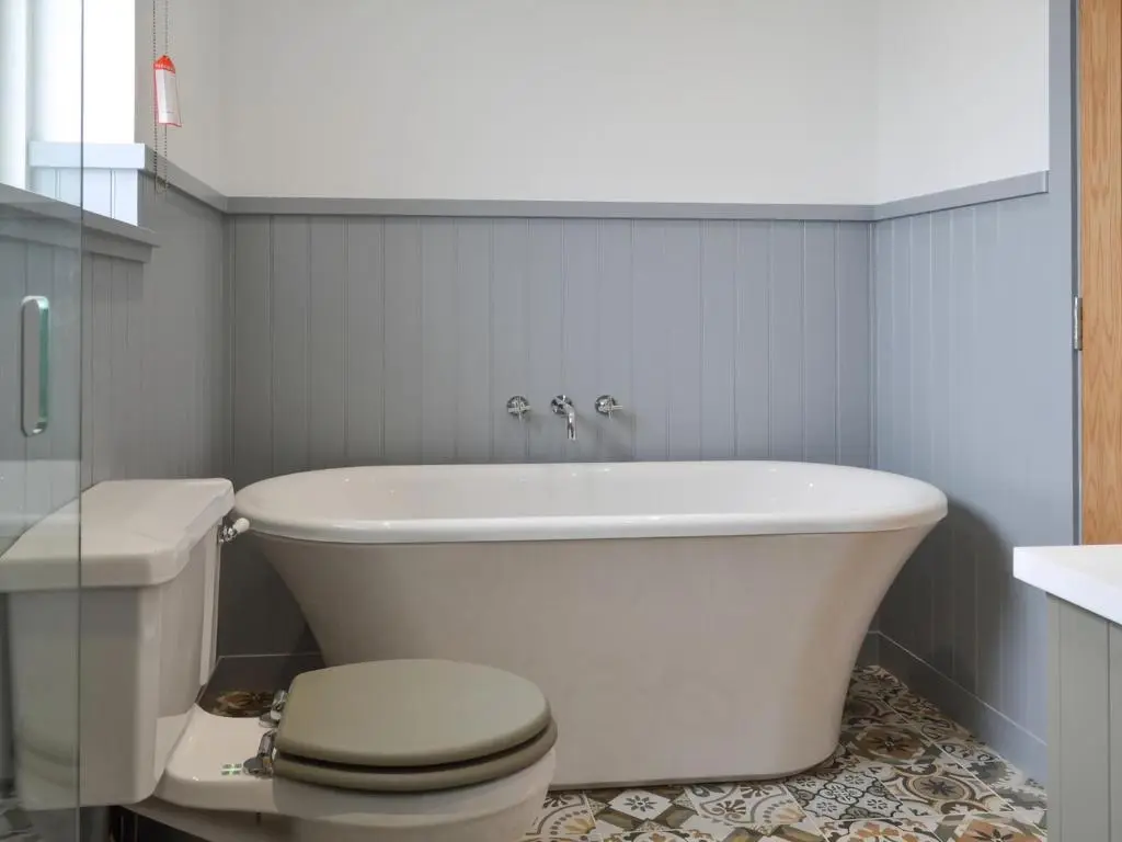 a bathroom with a white tub and a toilet at Muirtown Lodge in Keith