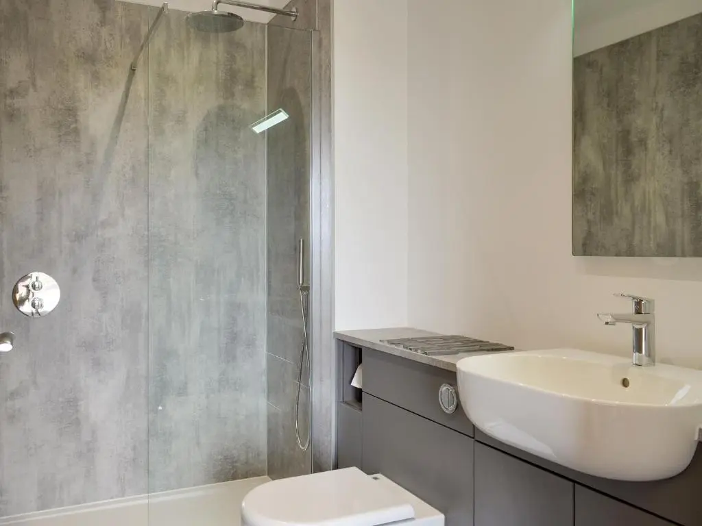 a bathroom with a sink and a toilet and a shower at Muirtown Lodge in Keith
