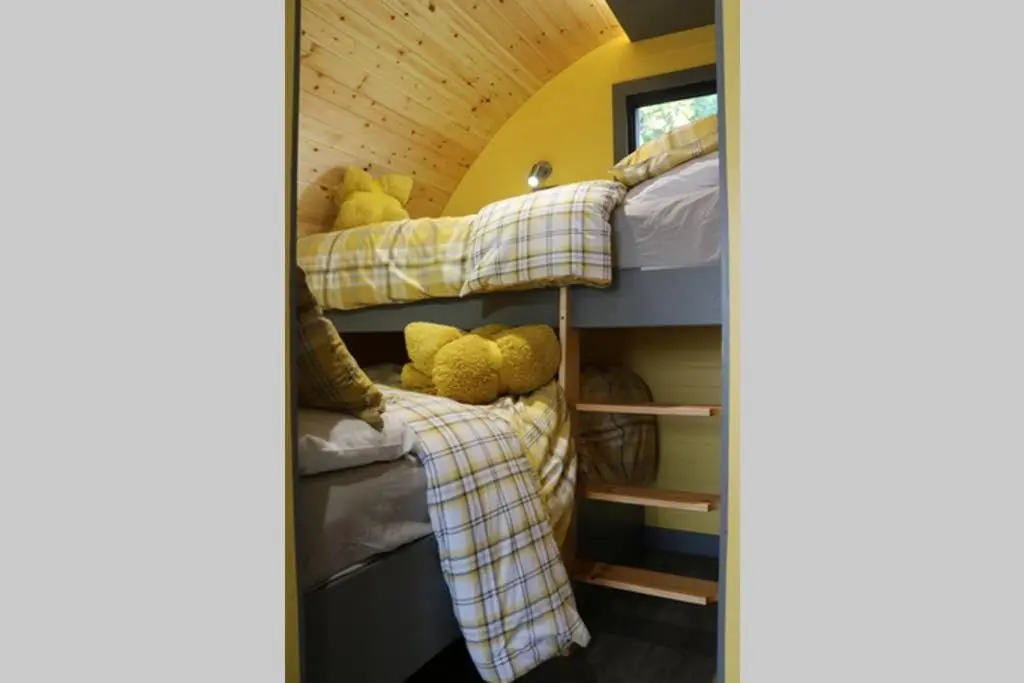 a group of bunk beds in a room at Glampods Glamping Pod - meet Highland Cows and Sheep Elgin in Elgin