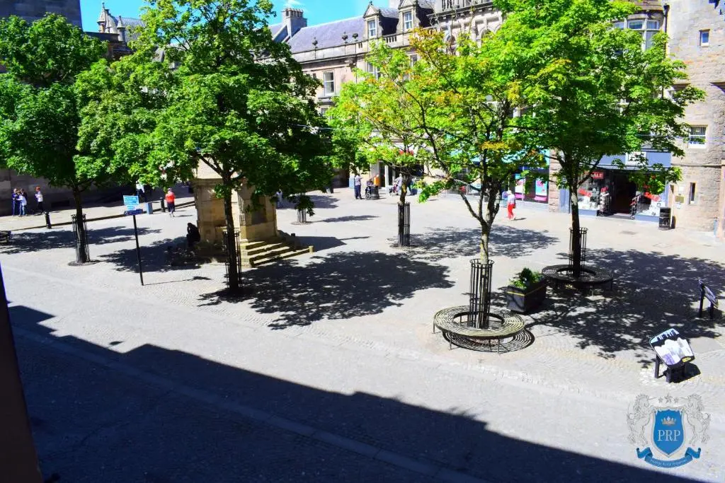 a city street with trees in a city at Two Bedroom Town Centre Apartment in Elgin