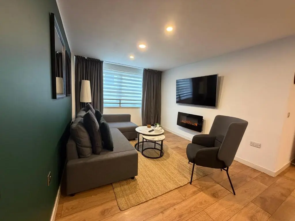 a living room with a couch and a chair at GRAPHITE APARTMENTS in Inverness