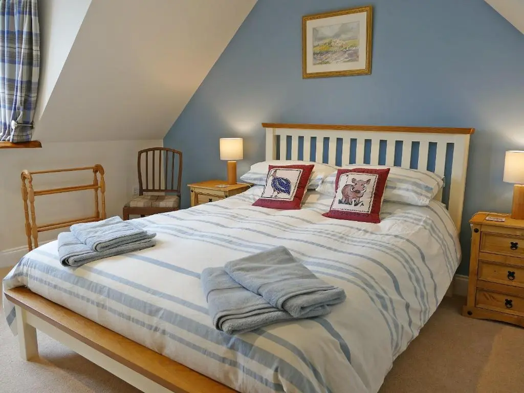 a bedroom with a bed with towels on it at Easter Lettoch in Advie