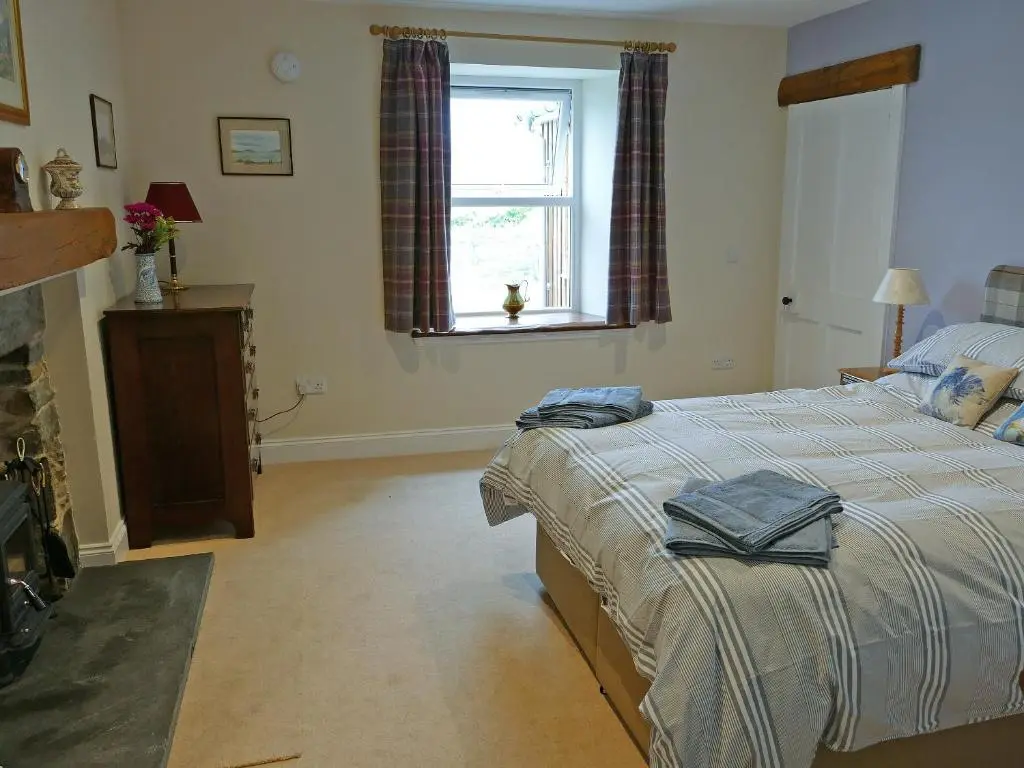 a bedroom with a bed and a window at Easter Lettoch in Advie