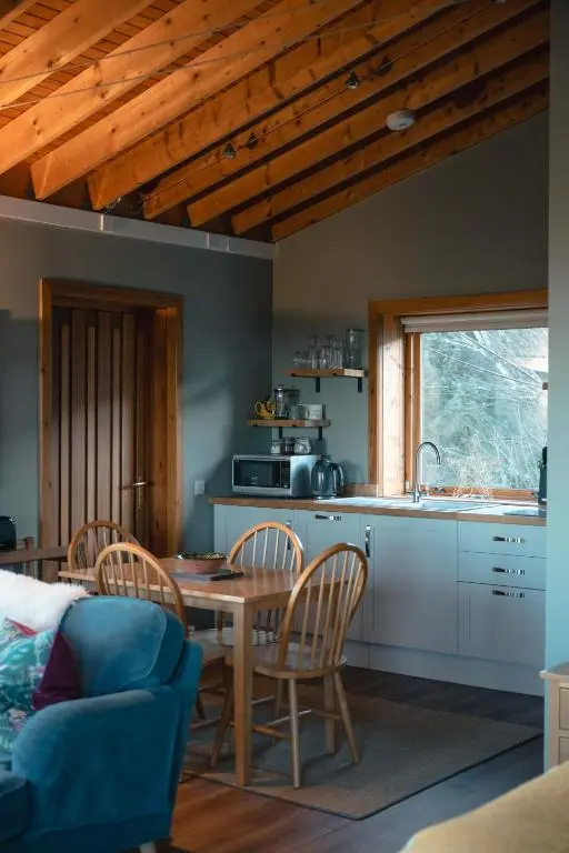 a kitchen and dining room with a table and chairs at The Bothy at Coneloch in Elgin