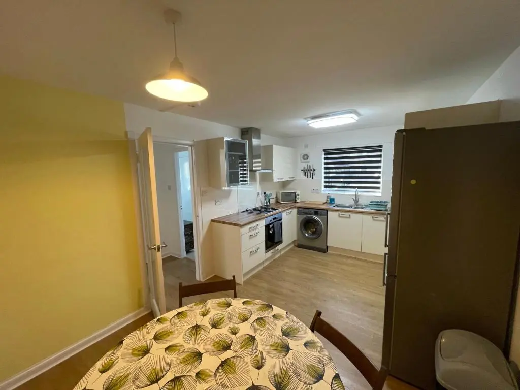 a kitchen with a table and a dining room at Lesmurdie Court, Serviced Accommodation Moray in Elgin