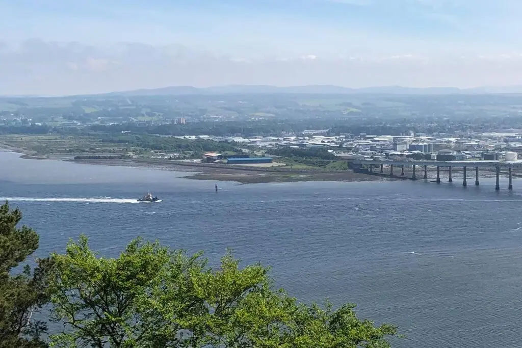 a boat in the water next to a bridge at The Annex at Bonnieview in Inverness