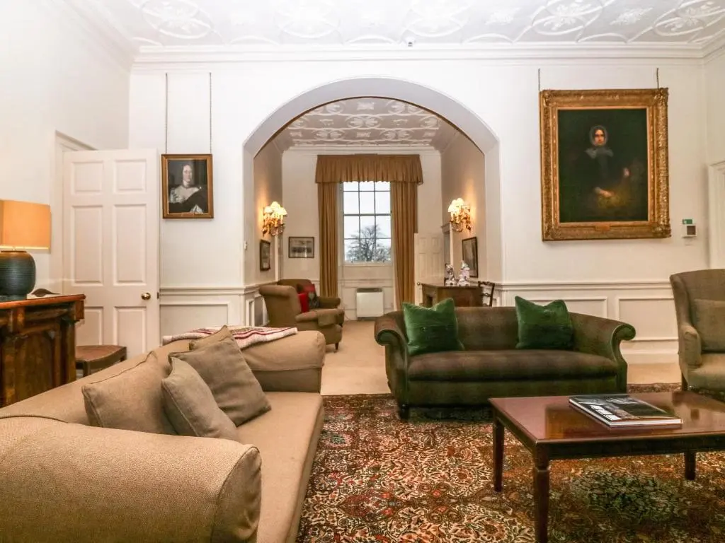 a living room with two couches and a table at The Preston Tower Apartment - Fyvie Castle in Turriff
