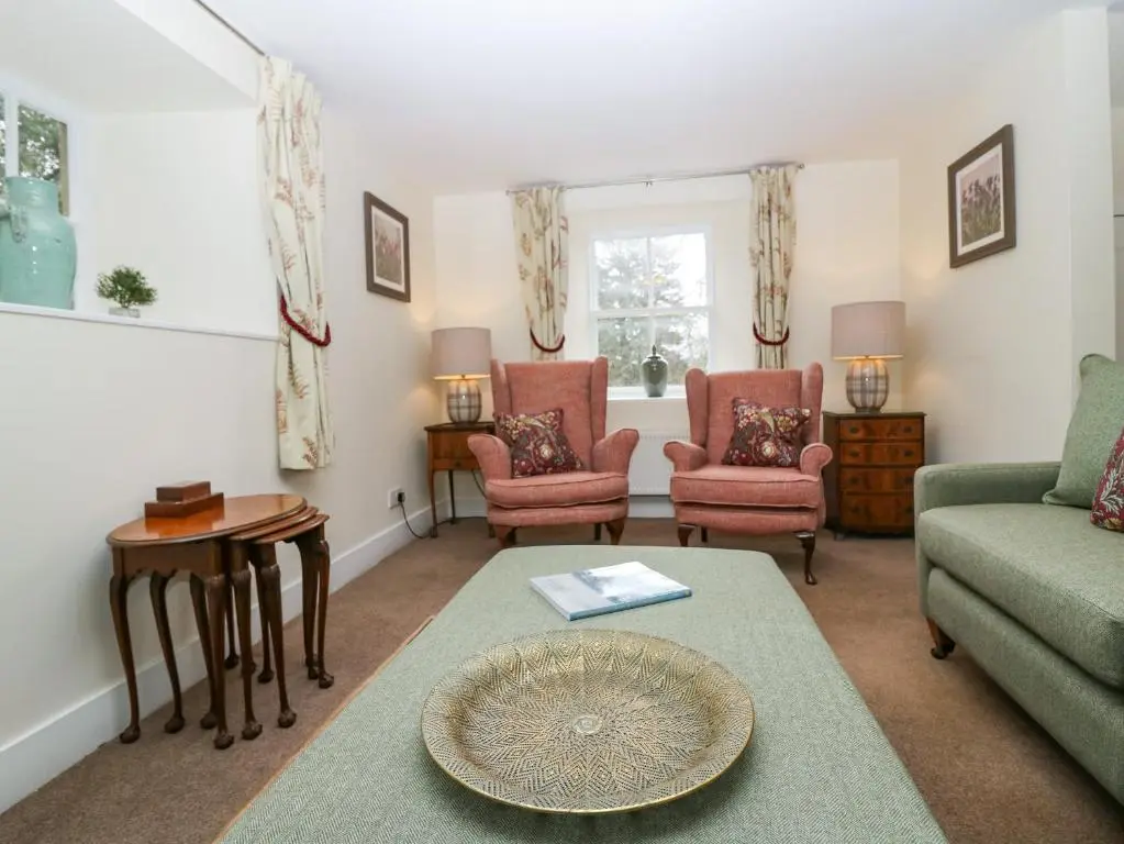 a living room with a couch and chairs and a table at North Mains Cottage - Craigievar Castle in Alford