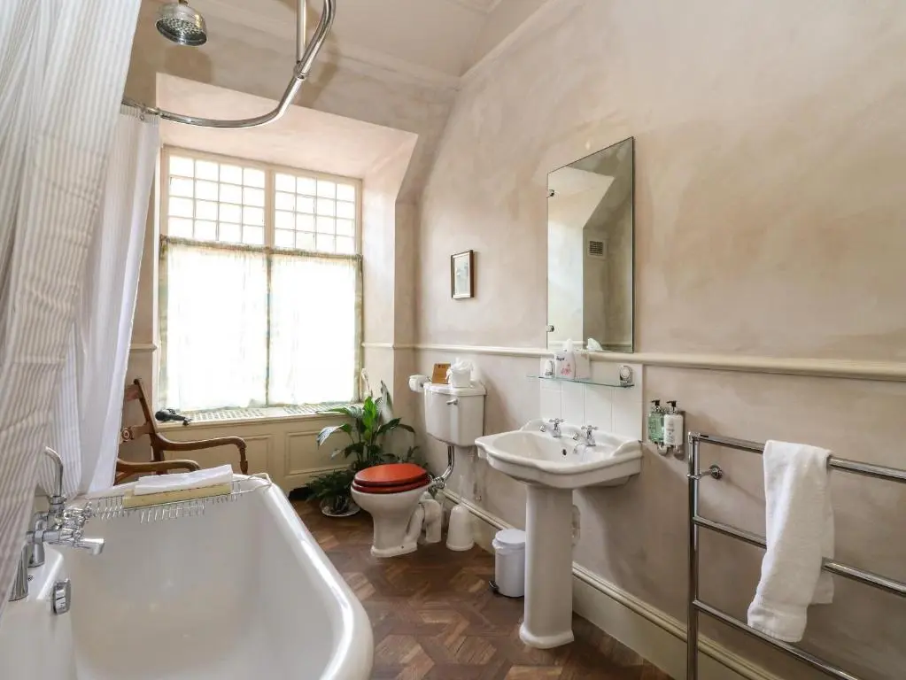 a bathroom with a tub and a sink and a toilet at Dalvorar - Mar Lodge Estate in Ballater