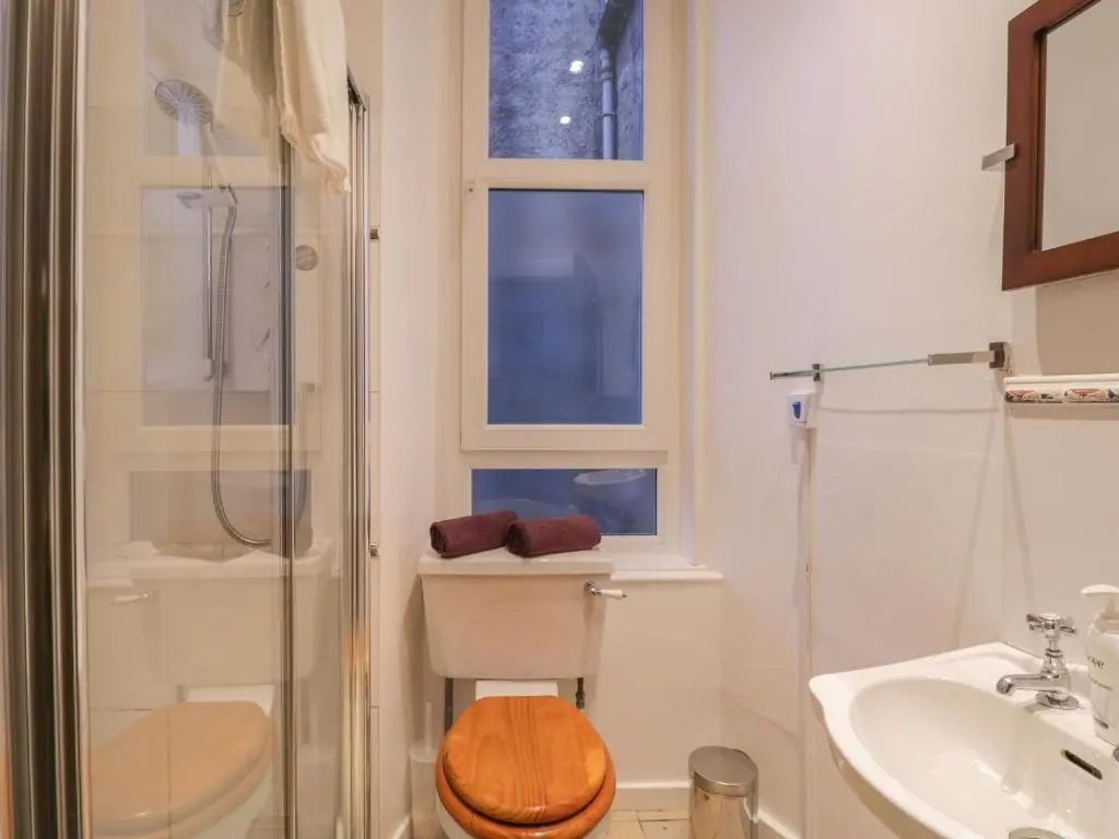 a bathroom with a shower and a toilet and a sink at Kinnaird House in Grantown on Spey