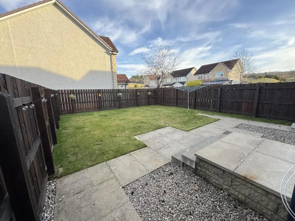 a backyard with a wooden fence and a lawn at No 25 Inverness - Home from Home in the Highlands in Inverness
