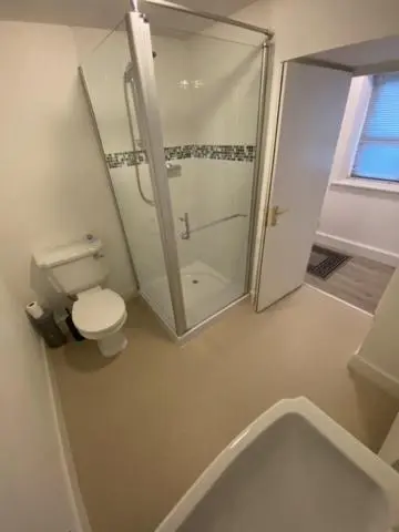 a bathroom with a toilet and a glass shower at Hill House - Mews Town House, in a quiet private close, in the City Centre of Inverness. in Inverness