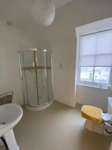 a bathroom with a shower and a toilet and a sink at Hill House - Mews Town House, in a quiet private close, in the City Centre of Inverness. in Inverness