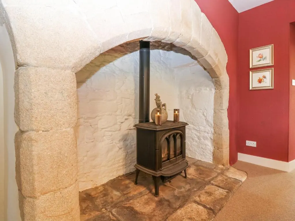 an archway with a stove in a room at North Wing - Pitmedden Gardens in Ellon