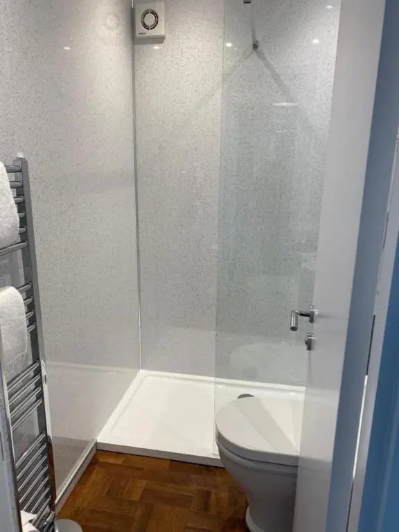 a bathroom with a shower and a toilet at Kinloch Lodge in Bearnock