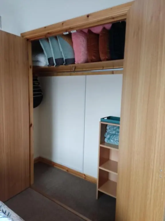 a room with a closet with a door open at Rooms at The Cooperage in Auchleven