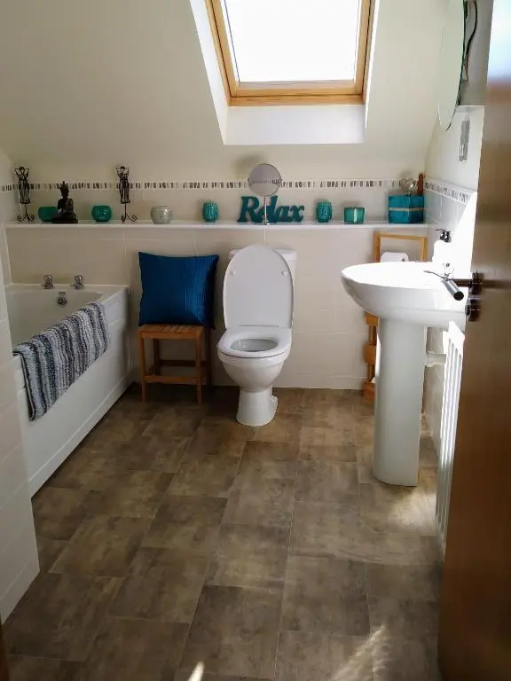 a bathroom with a toilet and a sink at Rooms at The Cooperage in Auchleven