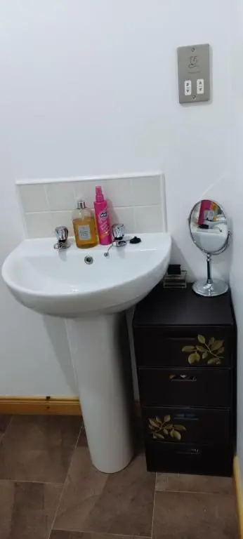 a bathroom with a white sink and a mirror at Rooms at The Cooperage in Auchleven