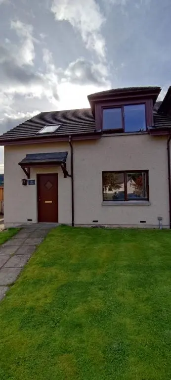 a house with a green lawn in front of it at Rooms at The Cooperage in Auchleven