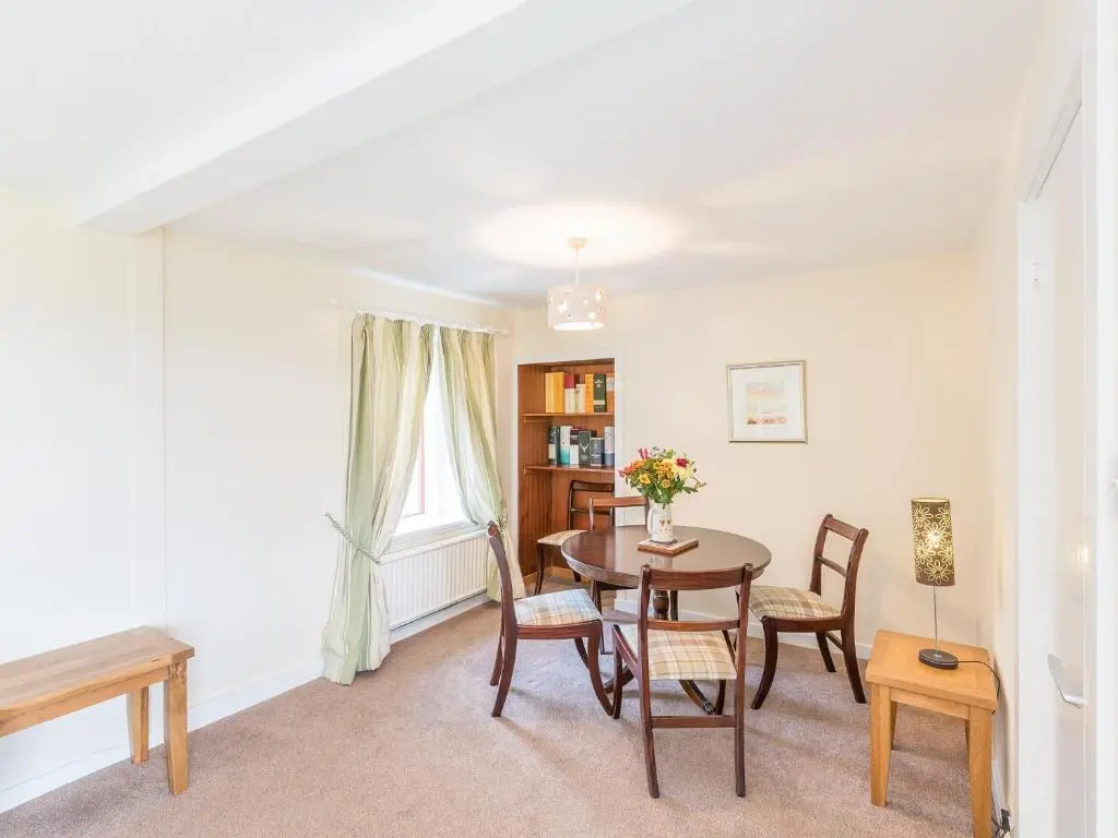 a dining room with a table and chairs at Balnain 1 in Cononbridge
