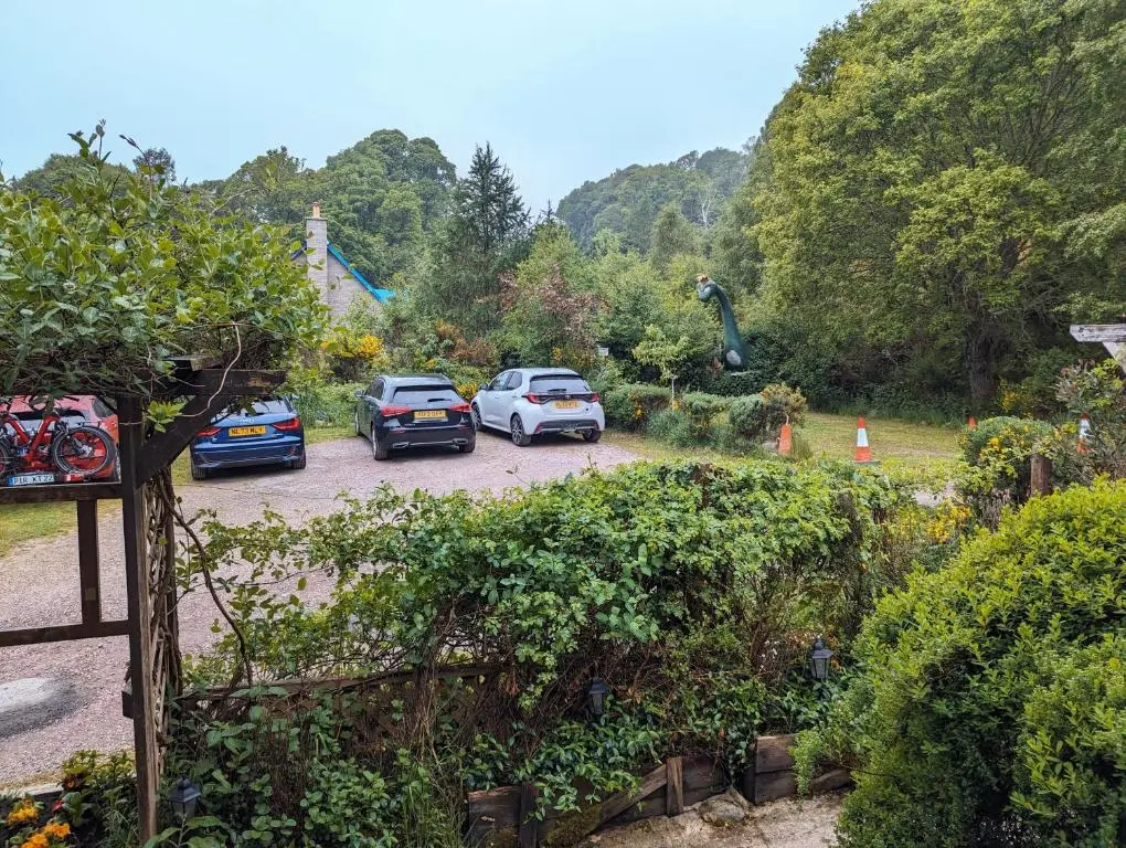 a group of cars parked in a parking lot at The Steading Highland Glen Lodge in Drumnadrochit