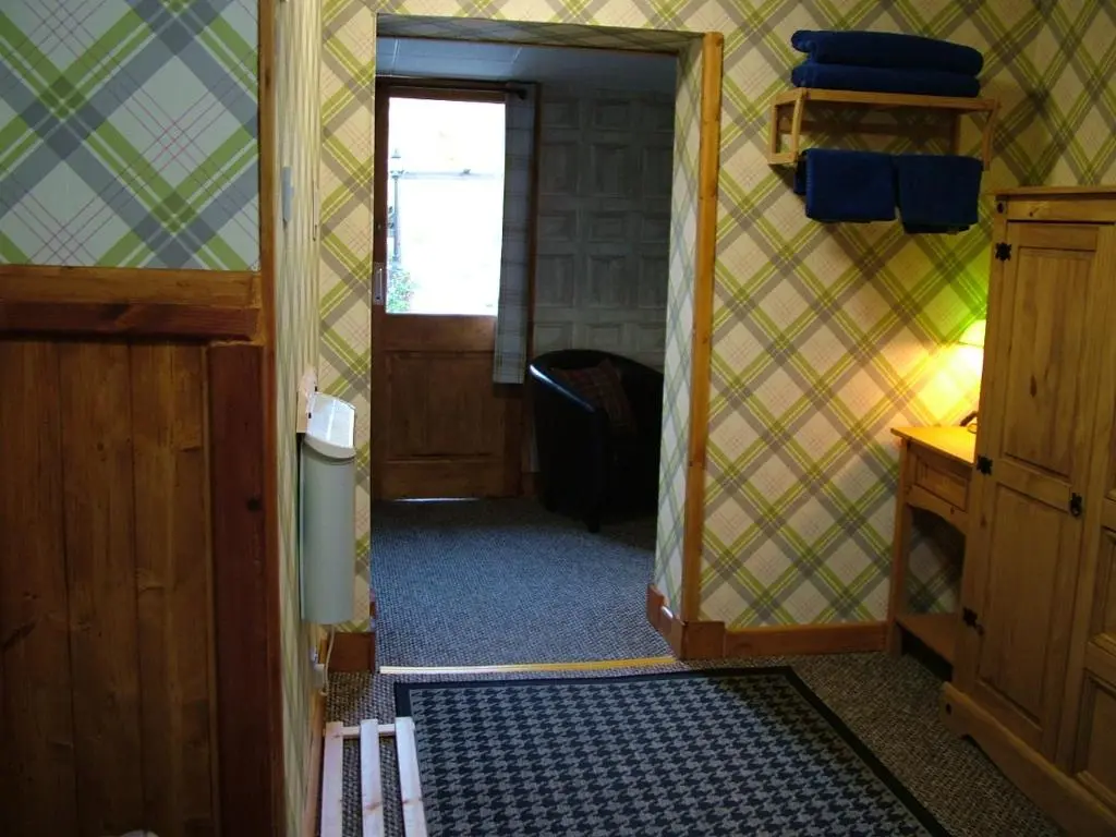 a hallway of a room with a door and a room with a door at The Steading Highland Glen Lodge in Drumnadrochit