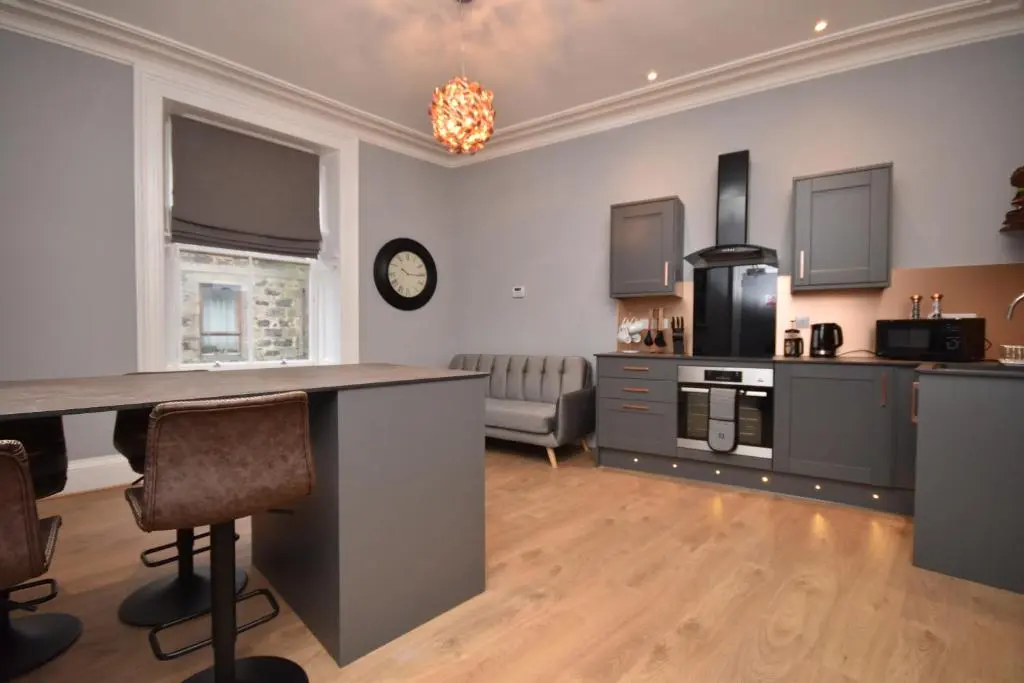 a kitchen and living room with a counter top at Signature Apartments in Fraserburgh