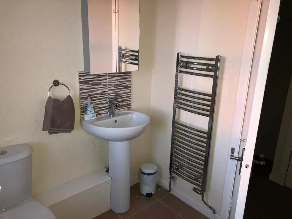 a bathroom with a sink and a toilet at PetFriendly-Beachfront-SunsetFacingSunPorch-Garden in Portmahomack