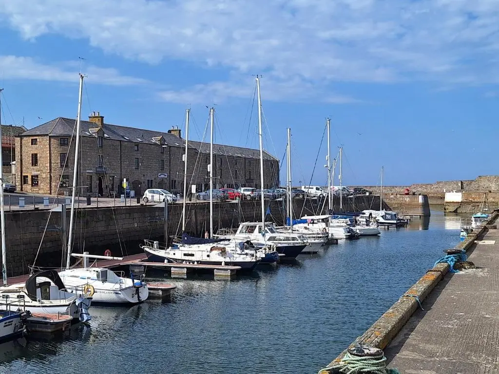 a bunch of boats are docked in a harbor at 1 Fulmar Road**Next to West Beach and Golf Course in Lossiemouth