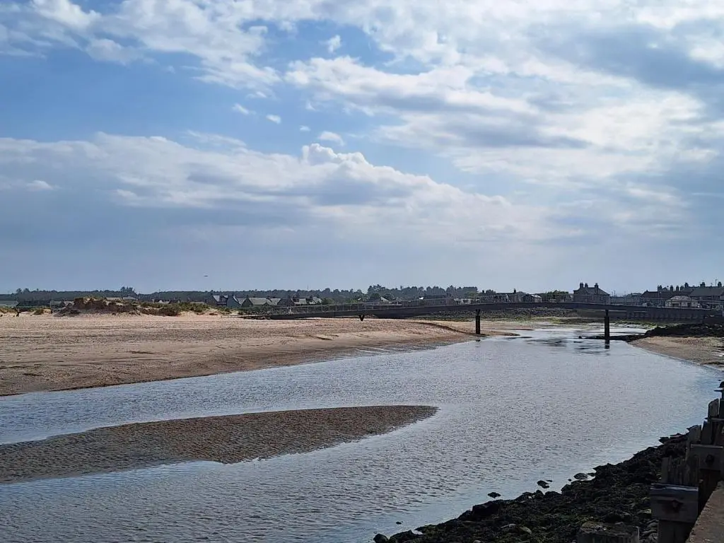 a body of water with a bridge in the background at 1 Fulmar Road**Next to West Beach and Golf Course in Lossiemouth
